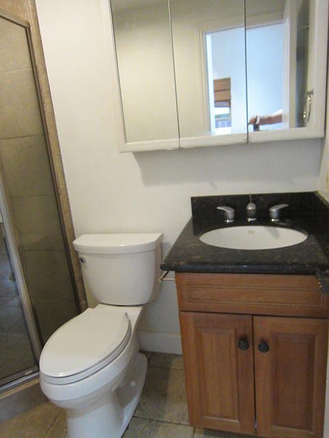 Glass shower surround with Ceramic Tile wainscoting.