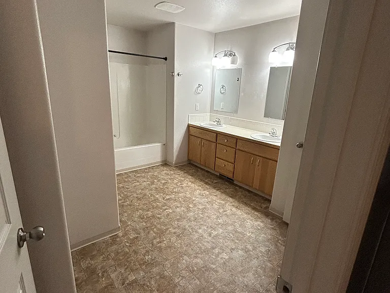 Large bathroom with double sink and separate toilet room