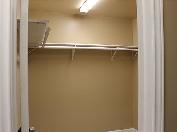 Spacious closet area upstairs with built in shelving.
