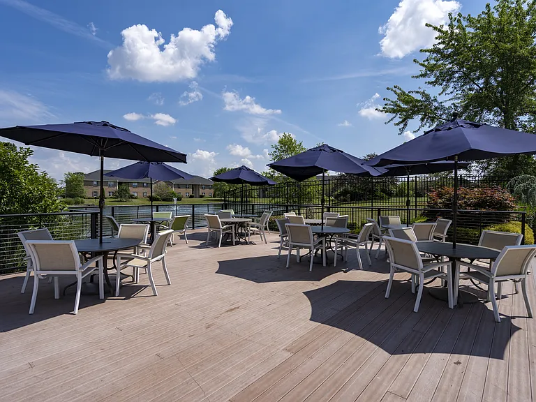 Enjoy your own outdoor retreat with a spacious deck, perfect for lounging under umbrellas and soaking up the fresh air.