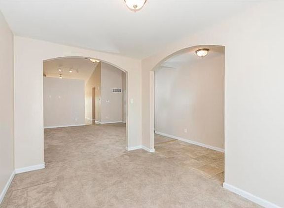 View from Dining Room of Entry to the right, Great Room and Kitchen/Breakfast Rooms beyond.