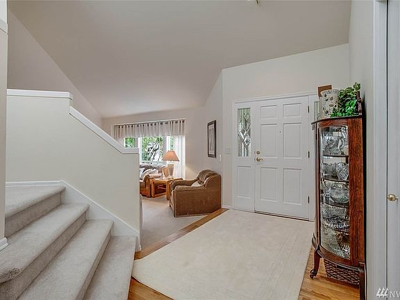 The entry is lovely with soaring ceilings, sweeping staircase and sunny skylight! You'll appreciate a large coat closet here as well.