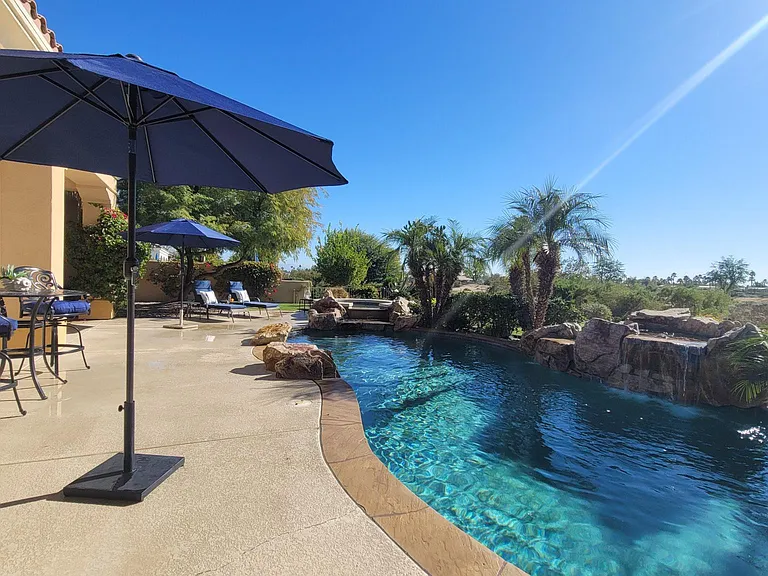 A large pool, waterfall, and spa, can be heated. View of the golf course and mountains.
