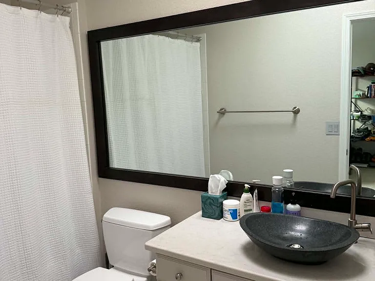 This is the ensuite bathroom, which has a modern look and lots of natural light via a skylight.