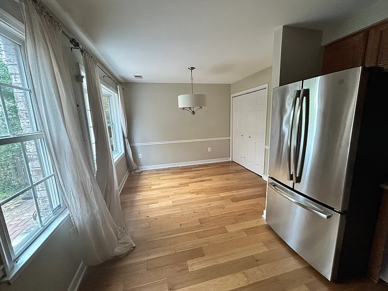 Open concept kitchen/dining area with adjoining laundry