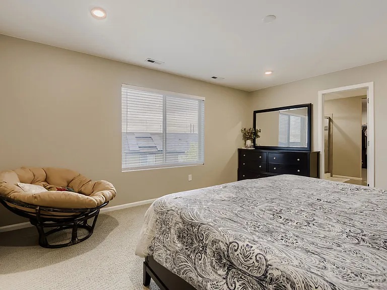 Large upstairs primary suite with a view overlooking the backyard