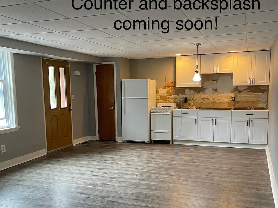 Kitchen/ first floor living room with entry door. Updated photos coming soon