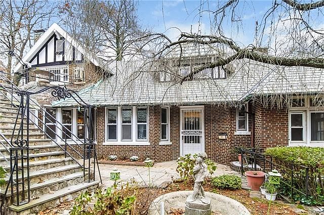 Main entrance with sculptures and garden.