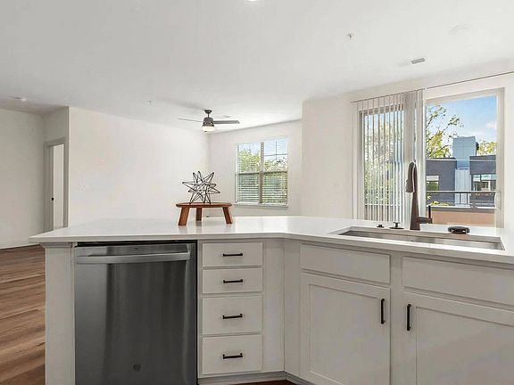 Spacious Kitchen with White Cabinets and Stainless Dishwasher