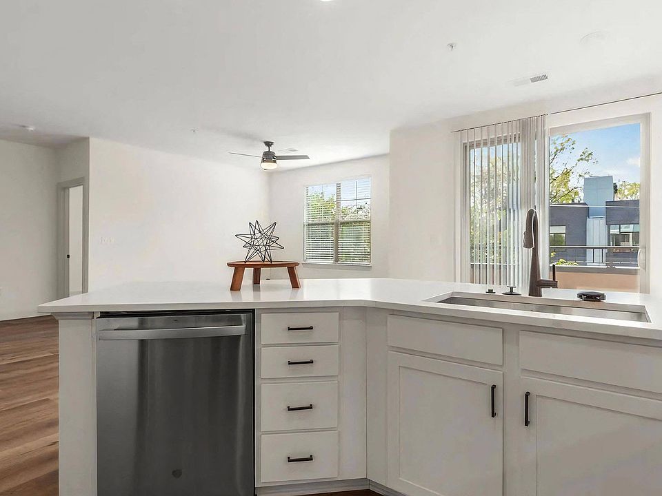 Spacious Kitchen with White Cabinets and Stainless Dishwasher