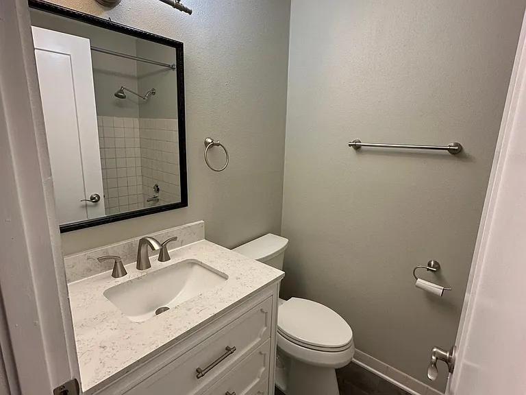 Bathroom 2 in the hallway of the unit with full-size bathtub