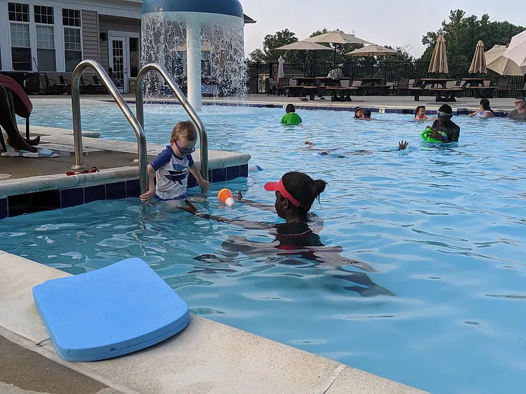 Neighborhood pool has wade-in area with splash features