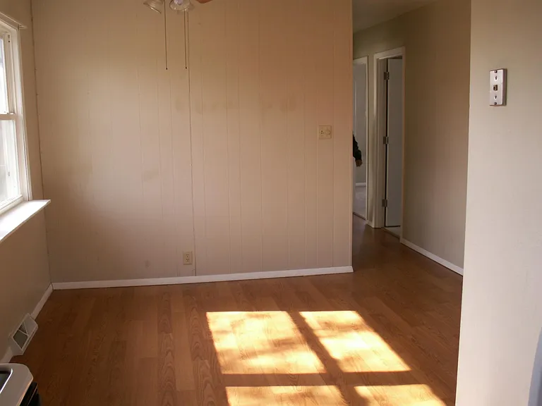 Dining area with large window overlooking backyard