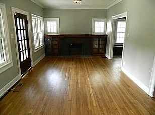 Living Room. Another view showing the fireplace and built-in glass cabinets.