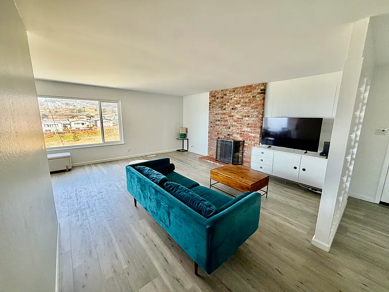 Living room with large TV and Gas Chimney