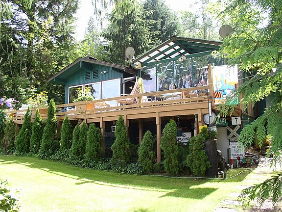 view of deck and house facing lake
