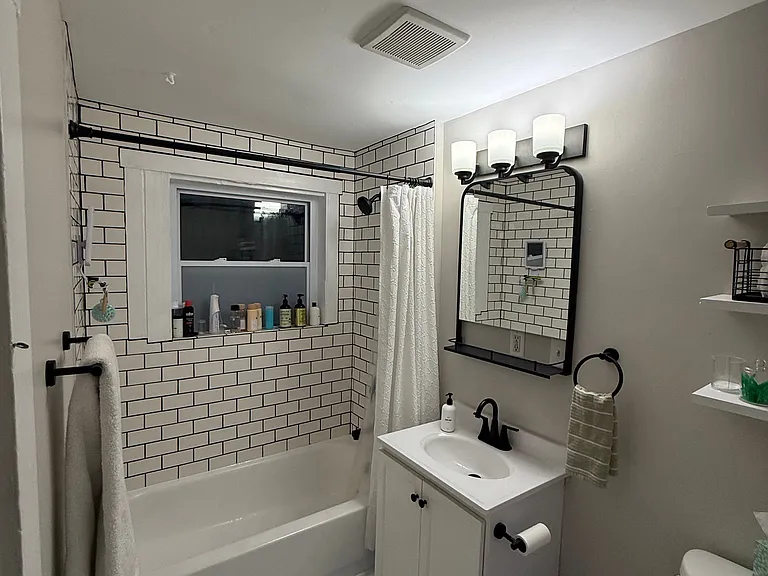 Subway tiled tub surround up to the ceiling!