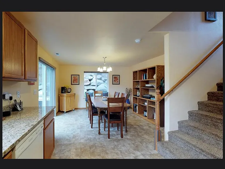 View from the kitchen _ stairs, dining room and sliding glass door onto backyard patio