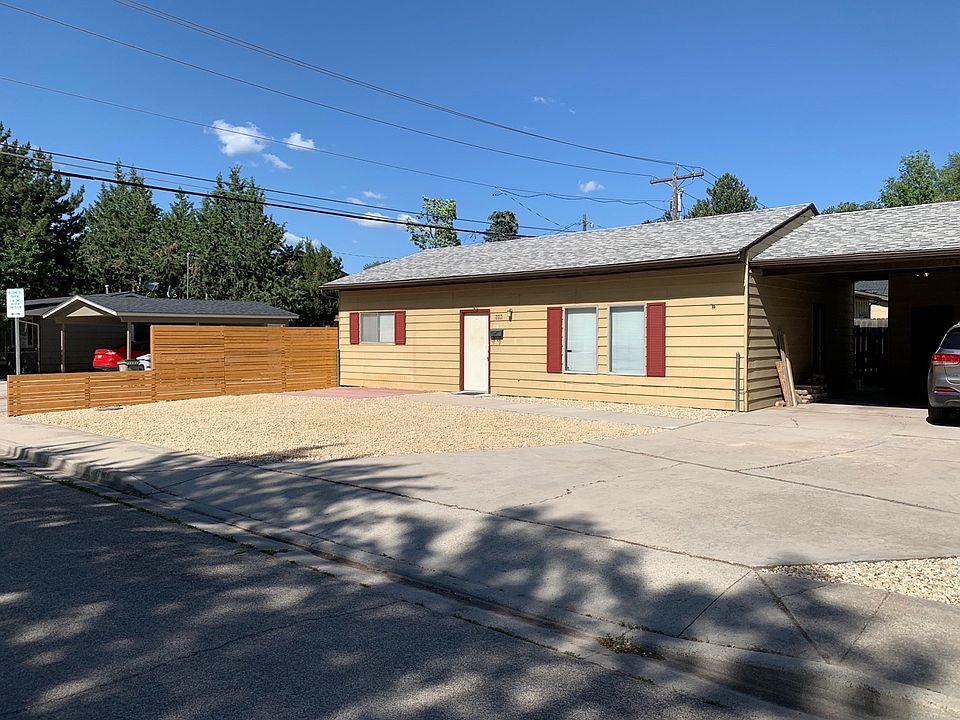 Front space includes paved patio area with sun shade (not pictured), and shared driveway with off-street parking and storage.