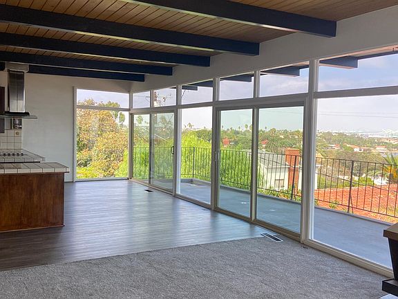 Open concept kitchen and dining room view of harbor and bridge.