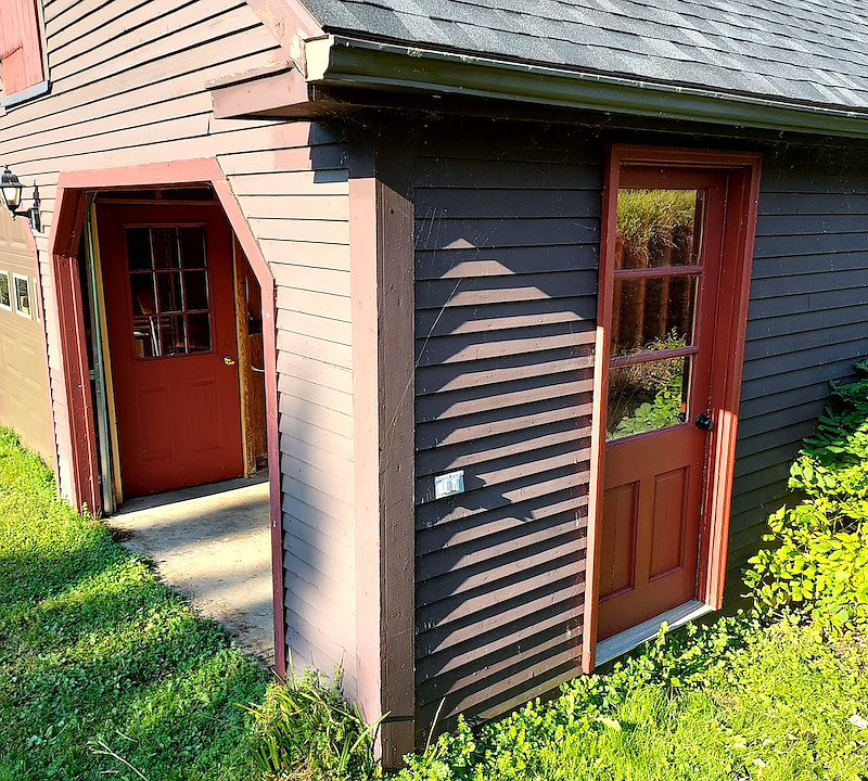 Side view of garage and private entry to the apartment. Tenant has use of one garage bay.