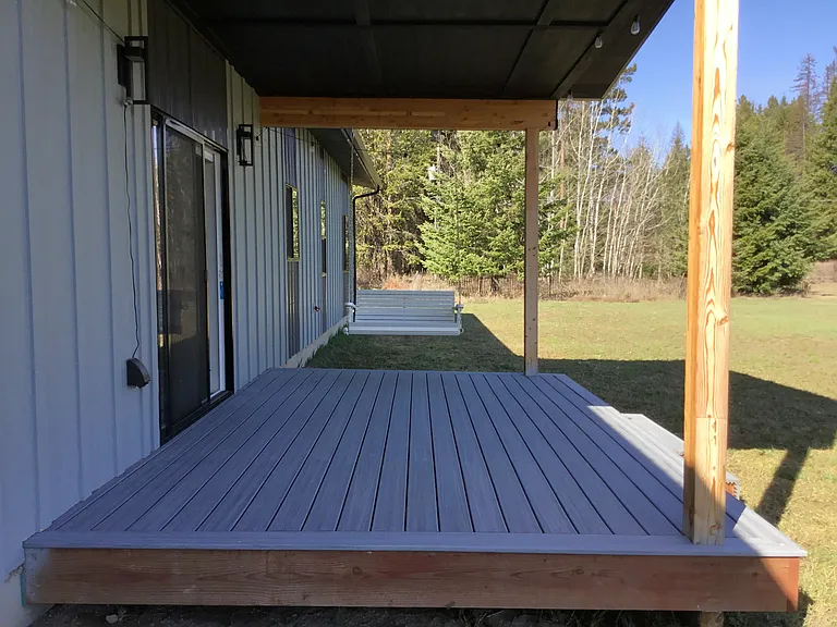 Spacious covered porch with a swing and plenty of room for outdoor dining, perfect for relaxing, entertaining.