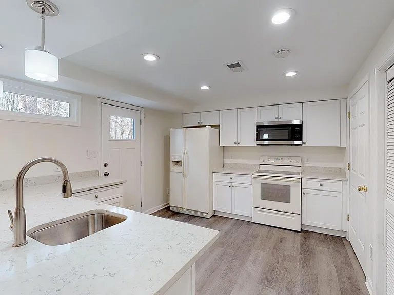 Open concept kitchen, new cabinets and countertops, new microwave, new dishwasher, new stove