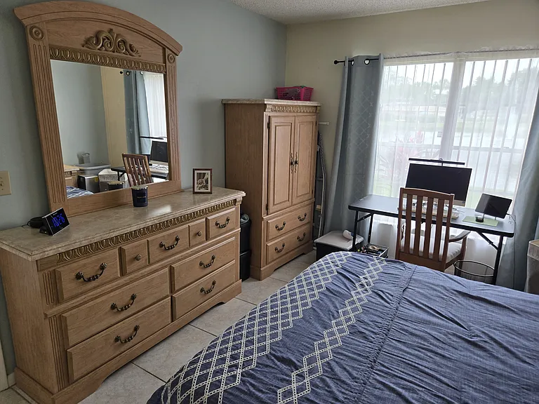 MASTER BEDROOM WITH QUEEN SIZED BED SUITE AND A GREAT VIEW OF THE LIGHTED FOUNTAIN POND