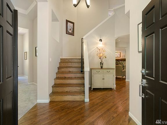 Inviting double-door entry showcasing the extensive hardwoods including stairs and more!
