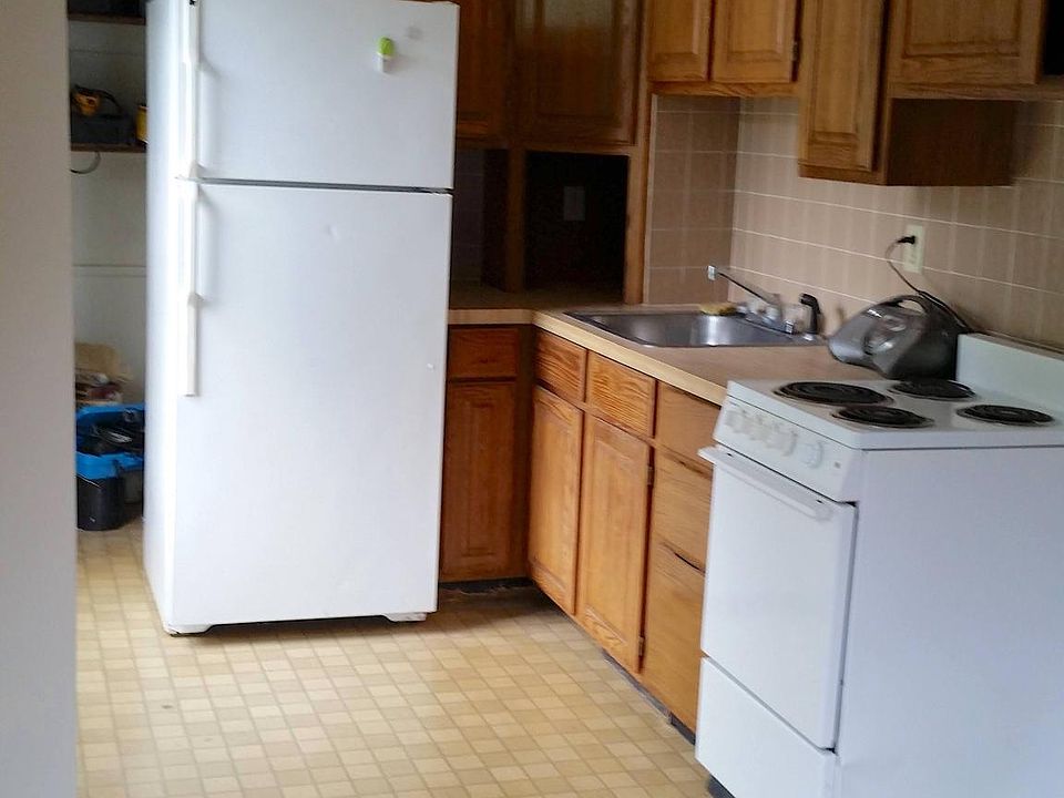 Bachelor's kitchen has extra pantry area next to fridge. Electric stove, cubby for appliances. Faces south so. always bright.