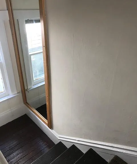 top of entry stairs with mirror