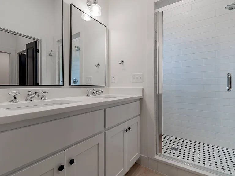 Main bathroom on main floor has double vanity.