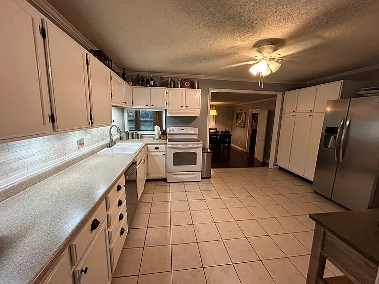 Enjoy this beautiful, spacious kitchen! Kitchen conveniently connects to the front living space and the main living room at the back of the home.