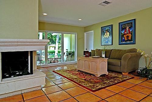 WRAPARROUND FIREPLACE FACES BOTH THE LIVING ROOM AND FAMILY ROOM