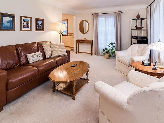 Lots of natural light brightens this clean and open living room.  Original cove ceilings.