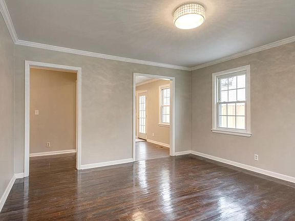 This is the view of the same living room, but now from the front door. You can see an additional window, the hallway on the left, and the kitchen entry on the right.