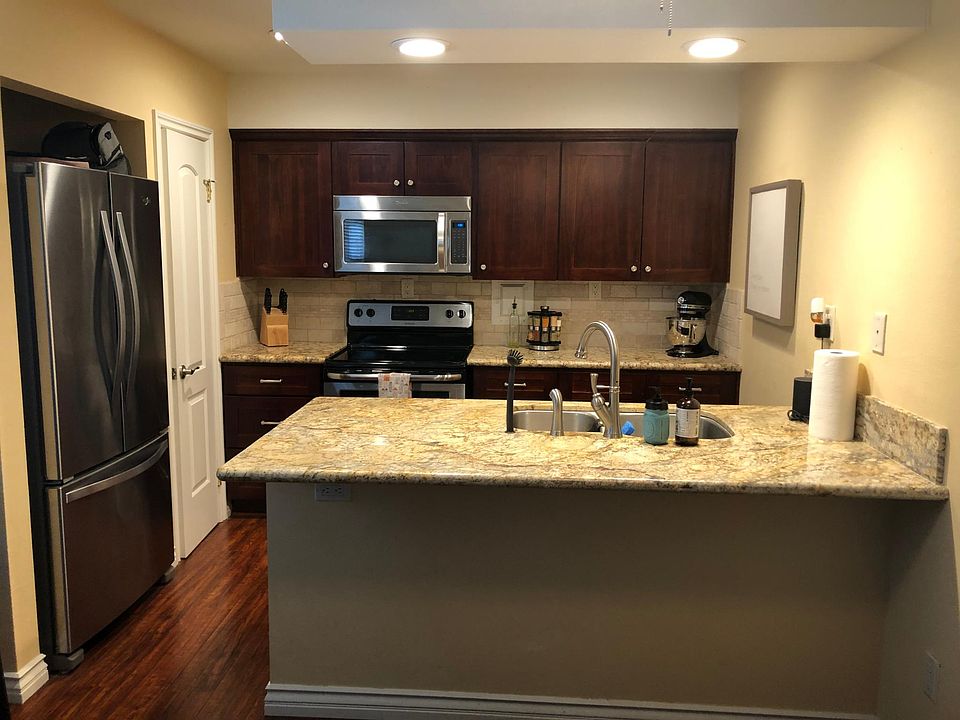 Kitchen, Breakfast counter, appliances, granite counters, custom cabinets and pantry door.