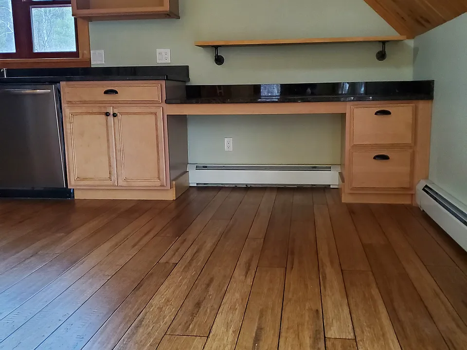 The built-in desk at the end of the kitchen counter.