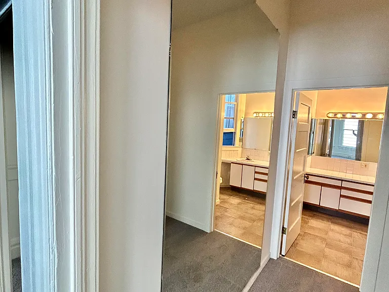 there is a large wall mirror in the mater bedroom closet
