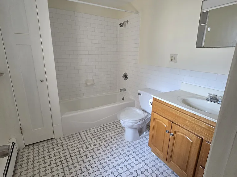Newly tiled bath with linen closet