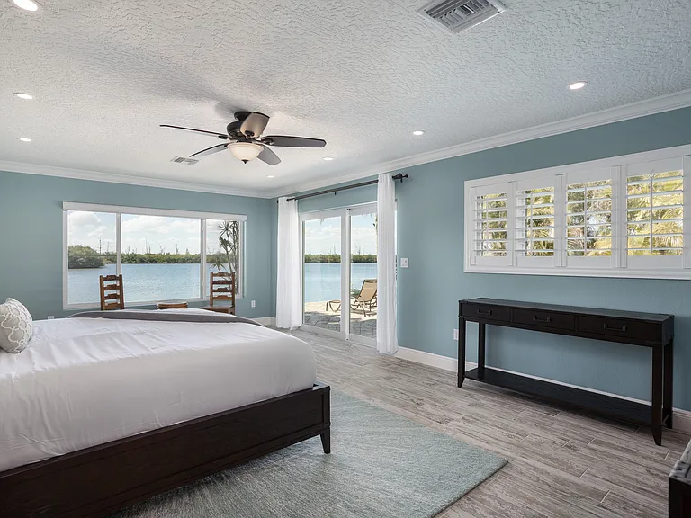 Primary Bed Room looking out to lagoon and pool deck