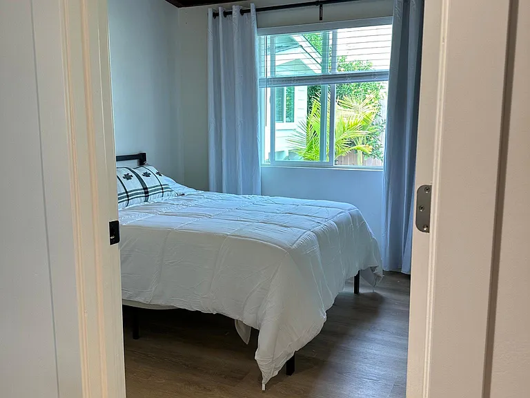 Lovely 2nd bedroom full size bed, comfortable mattress, no carpets! mirrored closet doors, wood beam ceiling, paddle ceiling fan.
