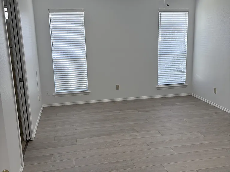 Primary bedroom from entrance, bathroom door on left