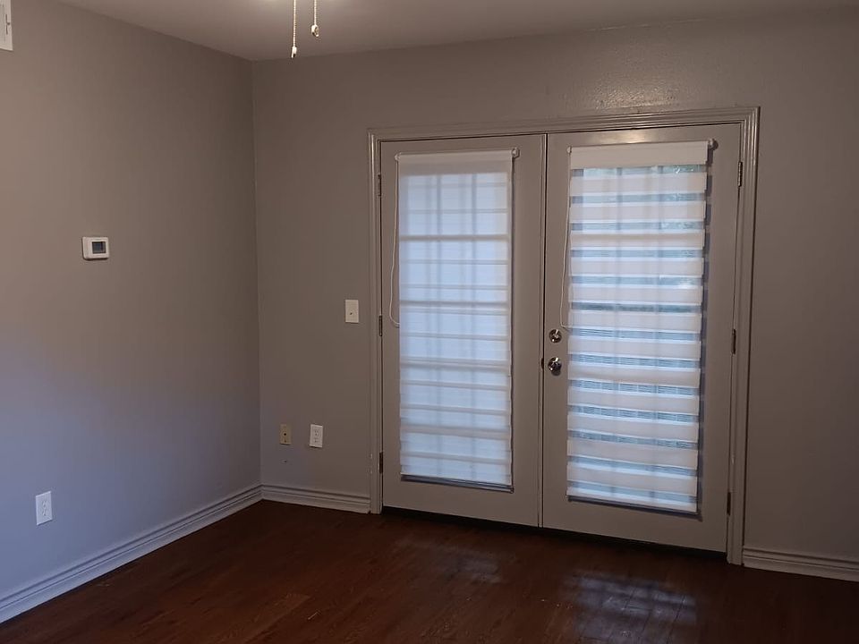French door that leads to a small covered porch by the woods