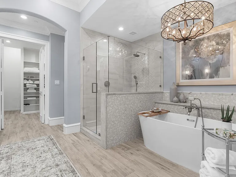 Ultimate relaxation awaits with a deep soaking tub and a modern glass shower.