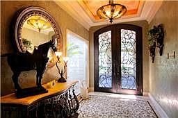 Impressive Entry with beautifully scrolled double doors and Tuscany pedant.