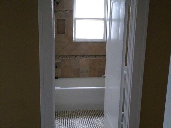 Renovated Tiled bathroom with linen closet