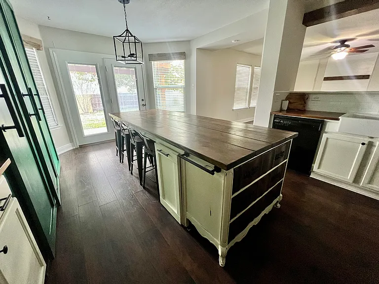 Kitchen with bench and chairs around island