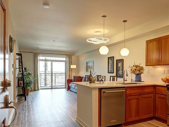 The view as you walk in the door. Kitchen, dining room and living room make up this great room concept complete with electric fireplace.