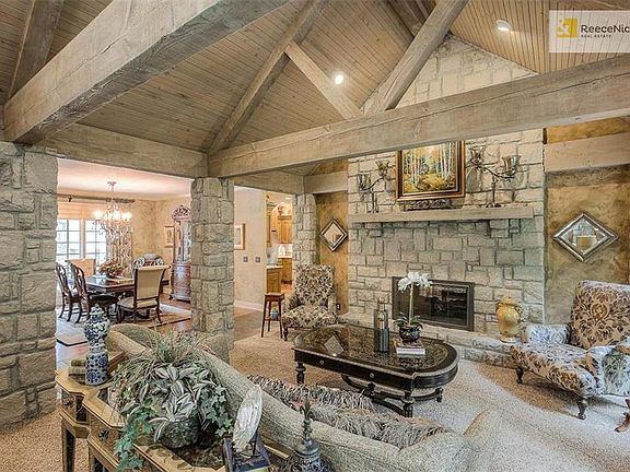 Impressive Great Room with vaulted beam ceilings and stone columns
